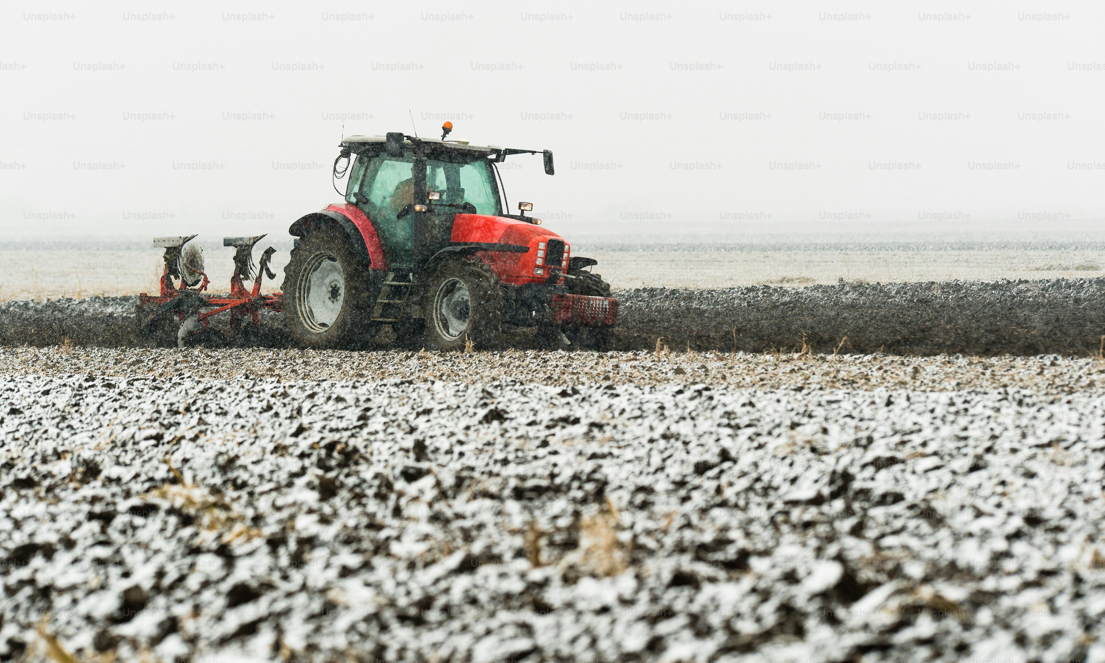 Tractor plowing a field in winter