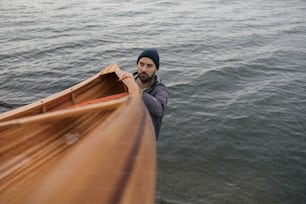 Fisherman holding canoe for a ride.