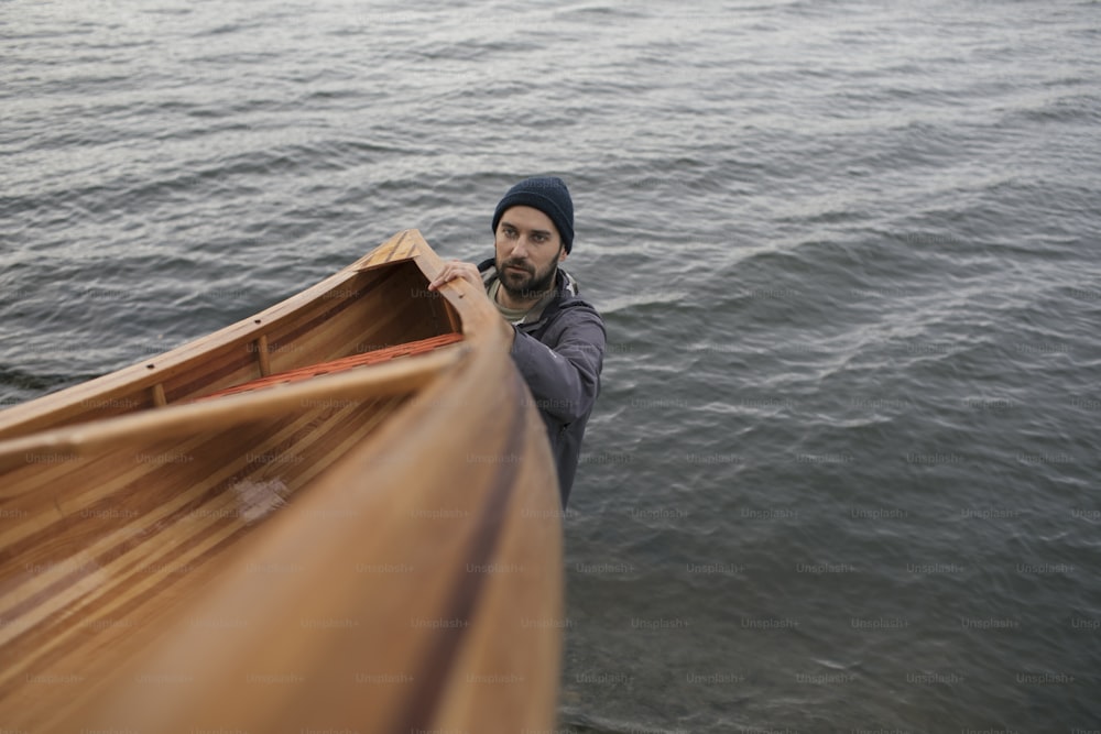 Fisherman holding canoe for a ride.