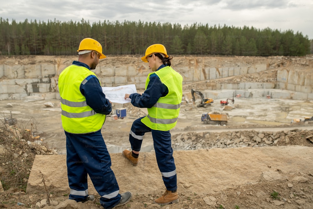 Two engineers discussing sketch of construction at workplace