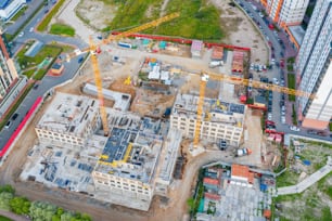 Aerial view of the beginning of the construction of the house, lower floors. Construction crane