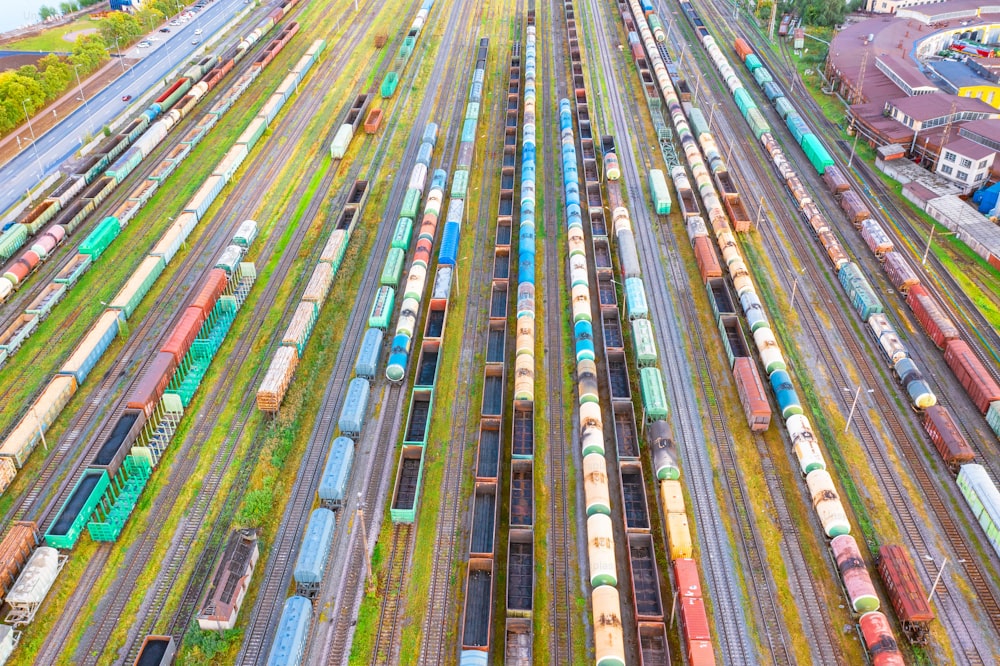 Aerial view flight over rail sorting freight station with various wagons, with many rail tracks railroad. Heavy industry landscape