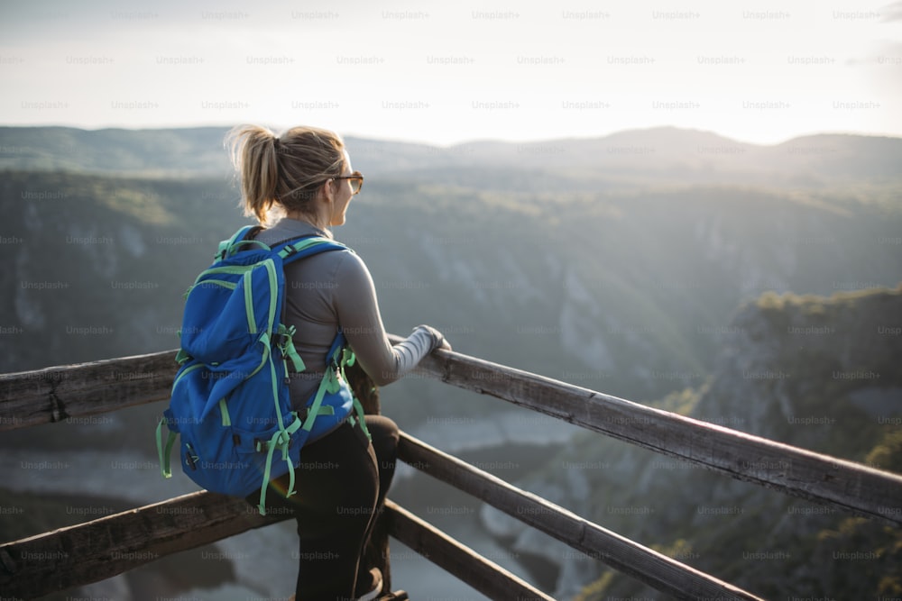 Young woman hiker at canyon viewpoint.