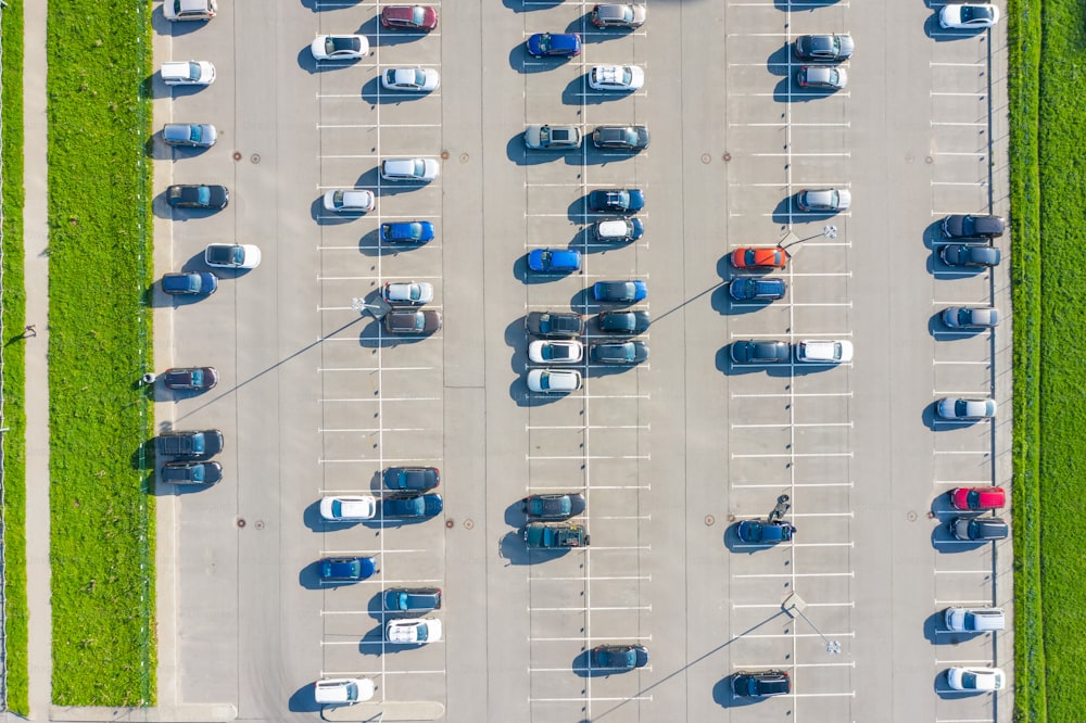 Aerial top down view of the parking lot with many cars of supermarket shoppers in the city grocery store