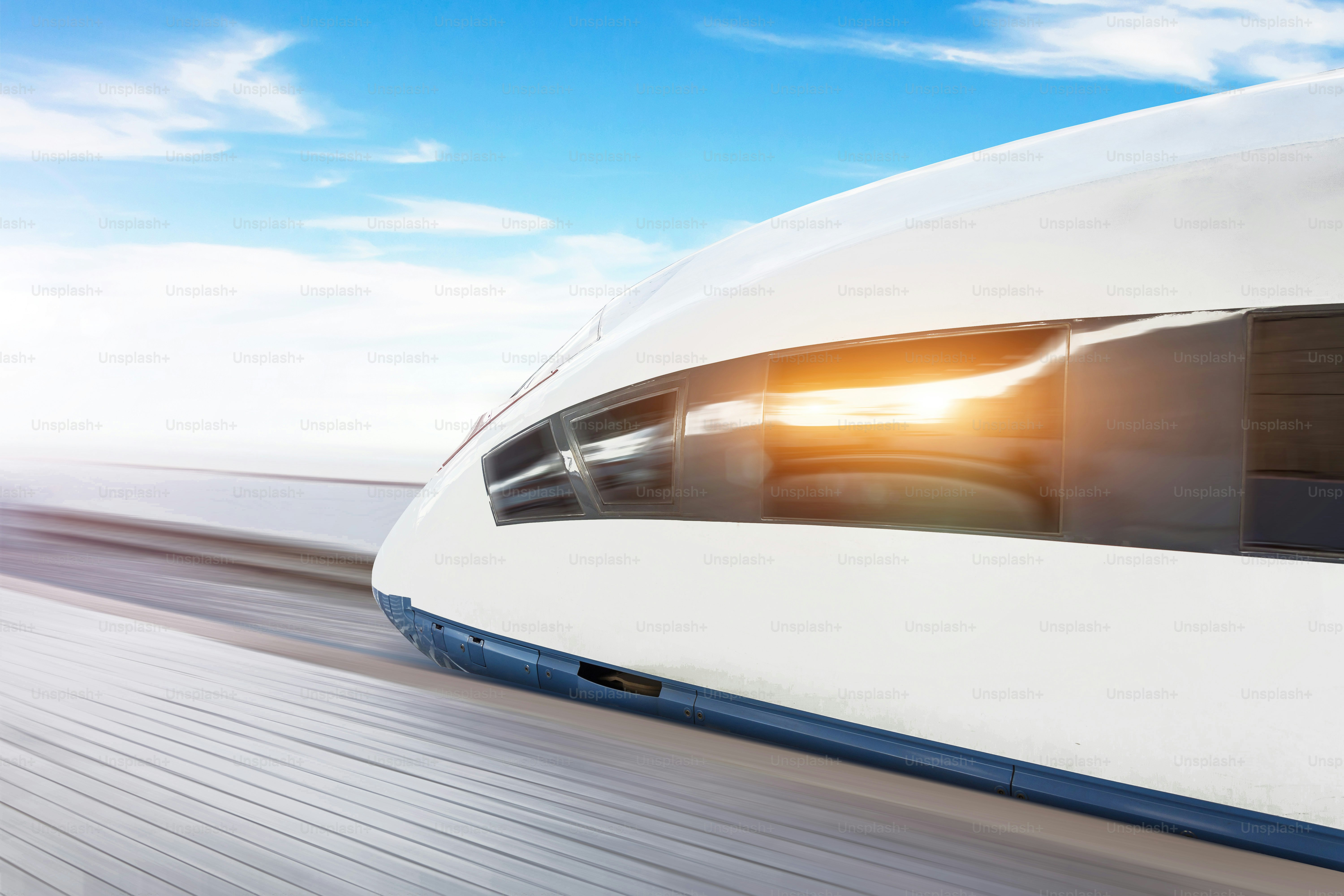 Railroad travel passenger train high speed with motion blur effect, against the blue sky