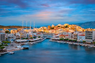 Beautiful Agios Nikolaos town on lake Voulismeni on sunset. Lasithi region of Crete island, Greece