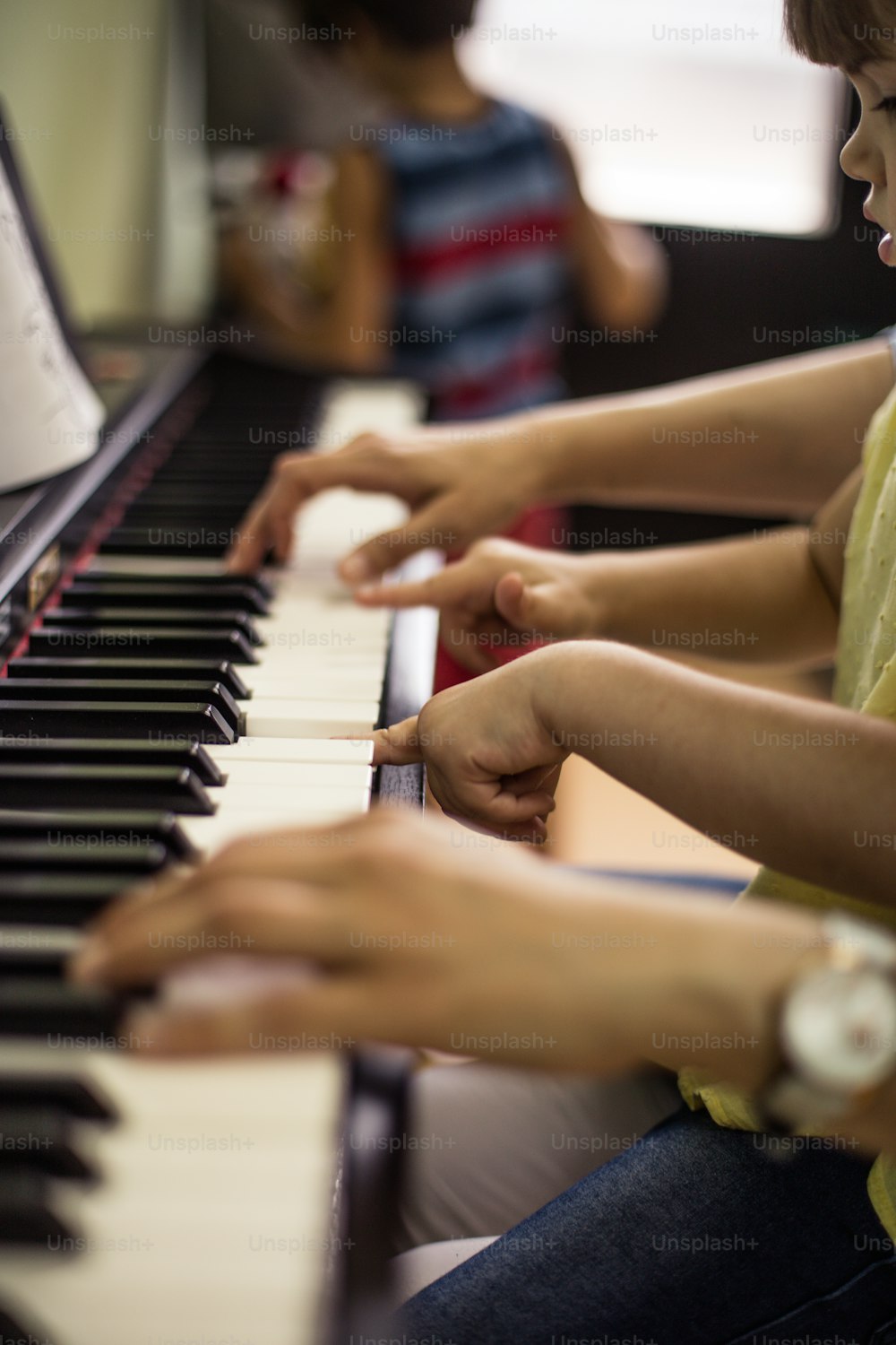 Your fingers know how to play. Child in music school with teacher.