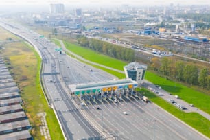 Top view aerial overloaded toll road or tollway on the controlled access highway, forced traffic jam