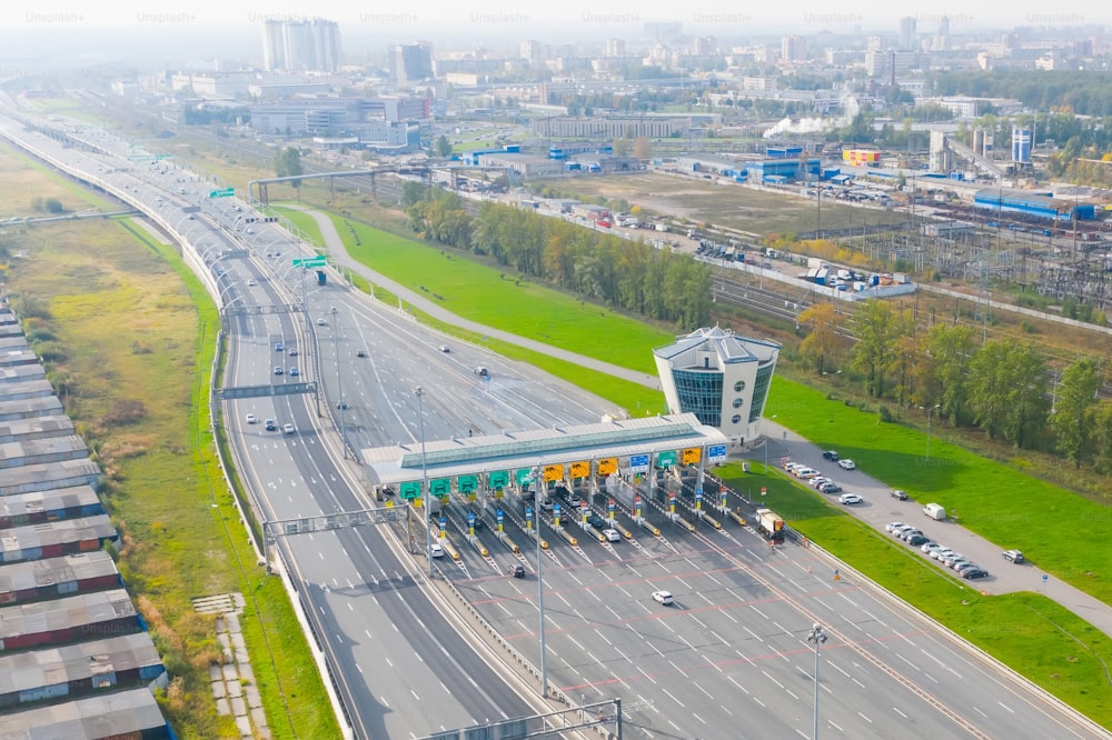 Top view aerial overloaded toll road or tollway on the controlled access highway, forced traffic jam