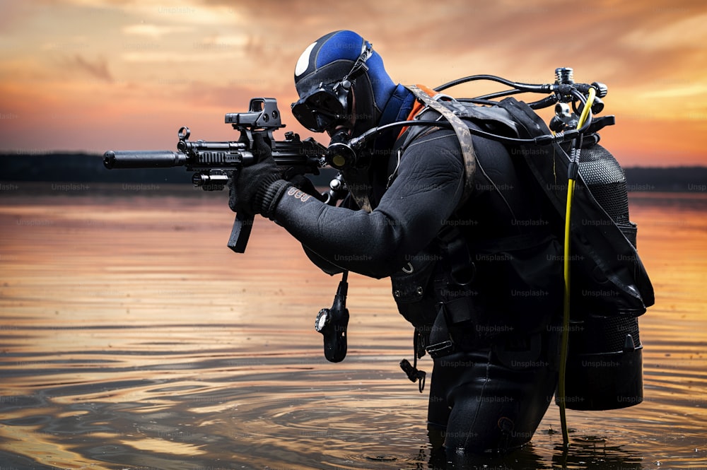 Der Marine kommt aus dem Wasser und bewegt sich mit Waffen in der Hand auf das Ziel zu. Das Konzept von Videospielen, Werbung, Instabilität in der Welt, Länderkonflikte. Mischtechnik