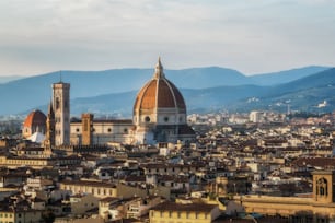 Florence Cathedral (Cattedrale di Santa Maria del Fiore) in historic center of Florence, Italy with panoramic view of the city. Florence Cathedral is the major tourist attraction of Tuscany, Italy.