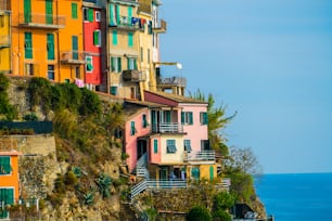 Colorful houses in Manarola Village, Cinque Terre Coast of Italy. Manarola is a beautiful small town in the province of La Spezia, Liguria, north of Italy and one of the five Cinque terre attractions.