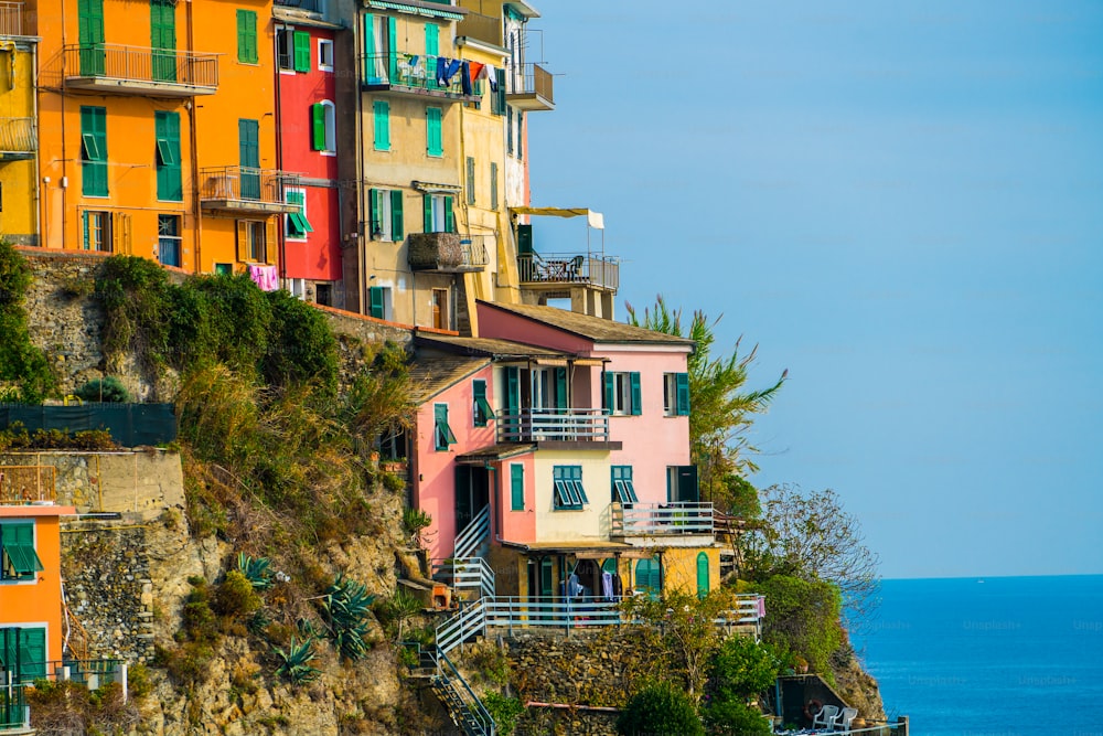 Colorful houses in Manarola Village, Cinque Terre Coast of Italy. Manarola is a beautiful small town in the province of La Spezia, Liguria, north of Italy and one of the five Cinque terre attractions.