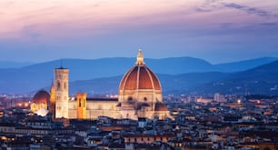 Florence Cathedral (Cattedrale di Santa Maria del Fiore) in historic center of Florence, Italy with night panoramic view of the city. Florence Cathedral is major tourist attraction of Tuscany, Italy.