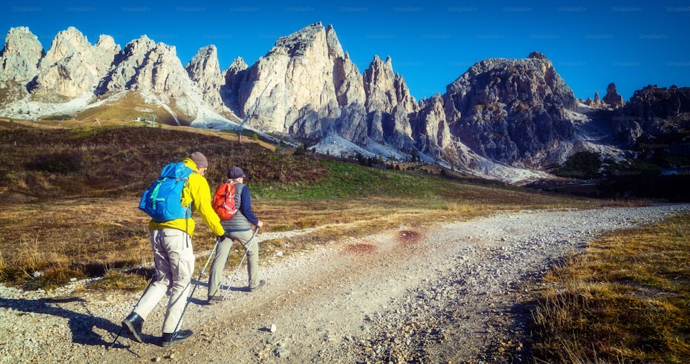 Travelers hiking in breathtaking landscape of Dolomites Mounatins in summer in Italy. Travel Lifestyle wanderlust adventure concept. Outdoor wilderness vacations.
