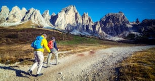 Travelers hiking in breathtaking landscape of Dolomites Mounatins in summer in Italy. Travel Lifestyle wanderlust adventure concept. Outdoor wilderness vacations.