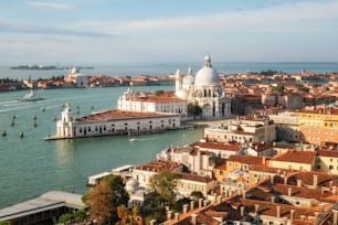 Aerial view of Venice, Italy with view of the Venice Grand Canal and Basilica Santa Maria della Salute in sunny summer. Venice is famous travel destination in Italy for its unique city and culture.