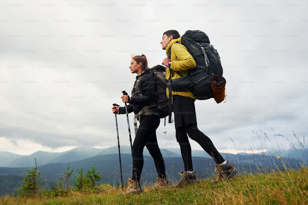 Hiking together. Woman and man. Majestic Carpathian Mountains. Beautiful landscape of untouched nature.
