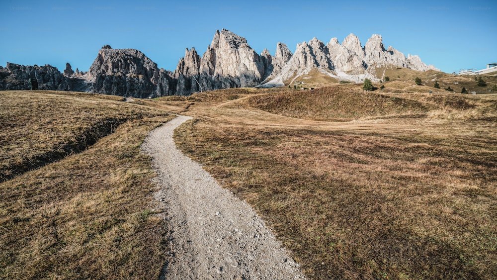 Dirt road and hiking trail track in Dolomites mountain, Italy, in front of Pizes de Cir Ridge mountain ranges in Bolzano, South Tyrol, Northwestern Dolomites, Italy.