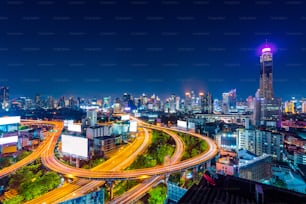 Cityscape and traffic at night in Bangkok, Thailand.