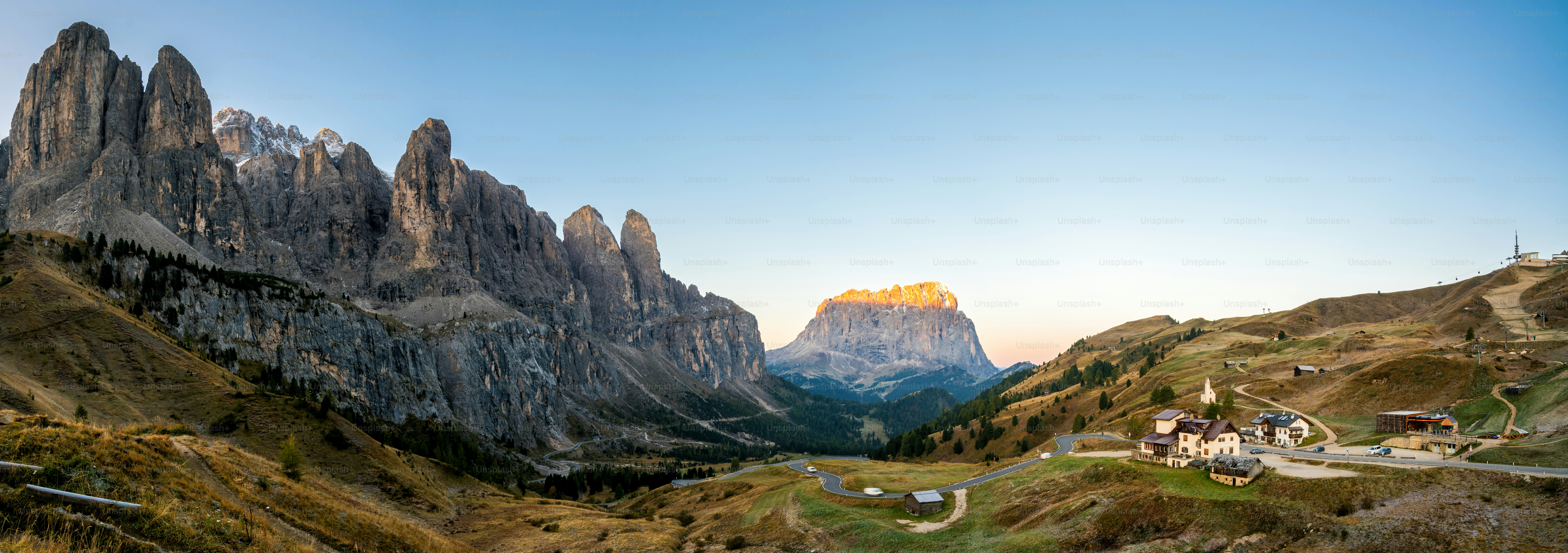 Dolomites Italy Panoramic Landscape. Sunrise shines on Sassolungo Langkofel Group, Passo Gardena, Western Dolomites travel and outdoor activity. Breathtaking landscape and travel in Northern Italy.