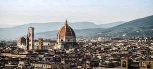 Florence Cathedral (Cattedrale di Santa Maria del Fiore) in historic center of Florence, Italy with panoramic view of the city. Florence Cathedral is the major tourist attraction of Tuscany, Italy.