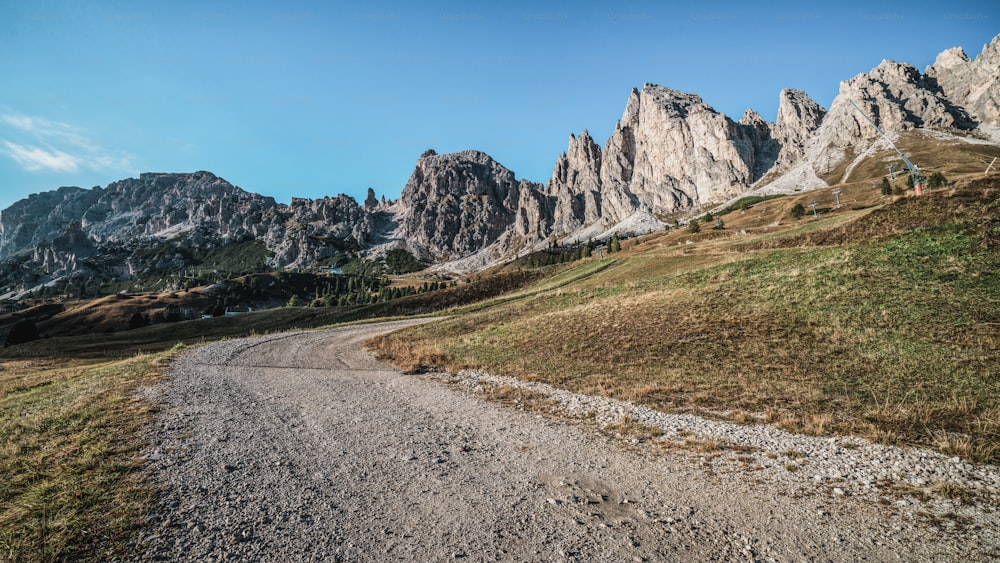 Dirt road and hiking trail track in Dolomites mountain, Italy, in front of Pizes de Cir Ridge mountain ranges in Bolzano, South Tyrol, Northwestern Dolomites, Italy.