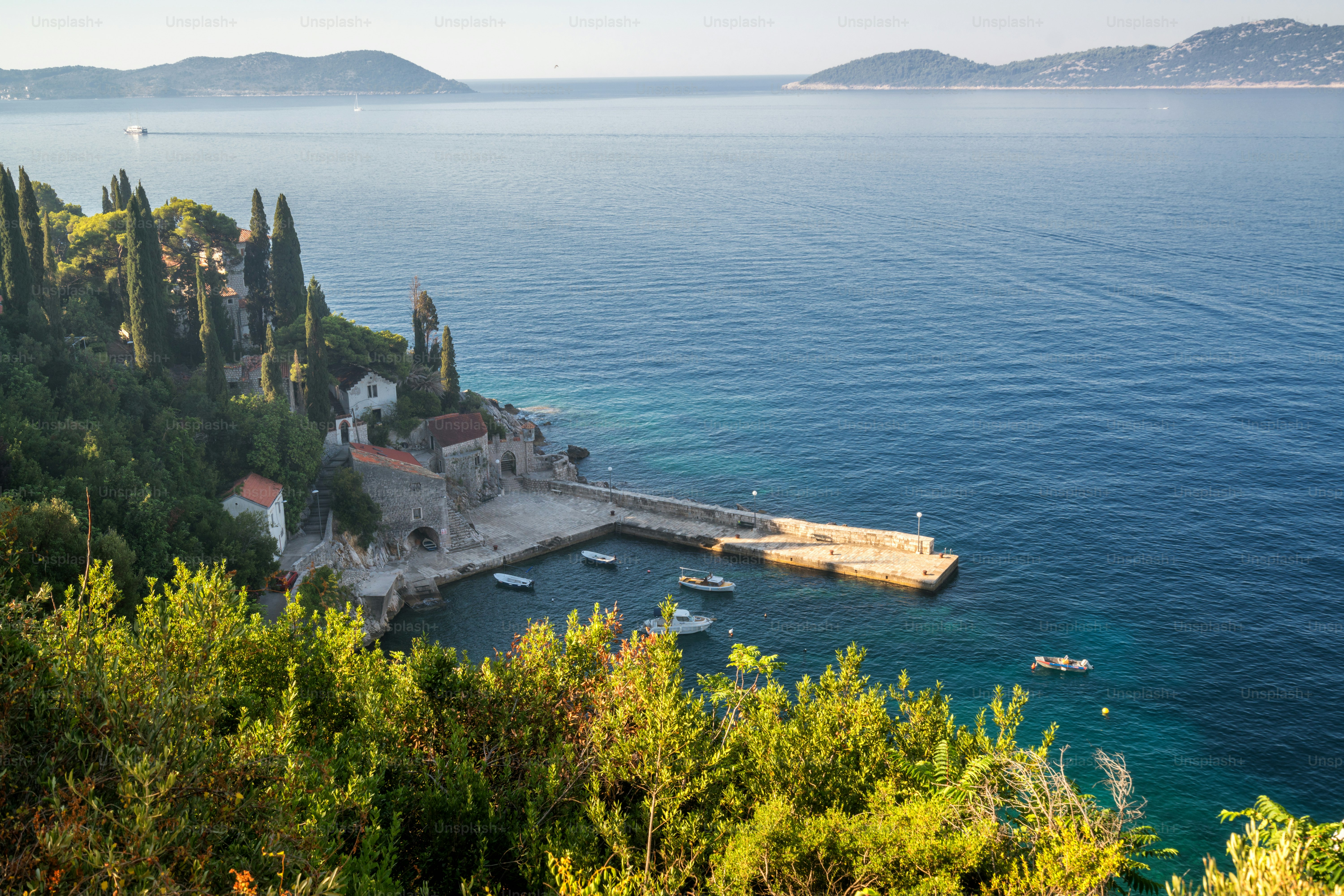 Adriatic coast with sunny harbor in Trsteno, Dalmatia, Croatia. Tourist attraction near Dubrovnik.