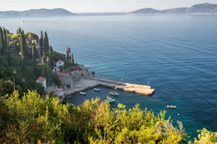 Adriatic coast with sunny harbor in Trsteno, Dalmatia, Croatia. Tourist attraction near Dubrovnik.