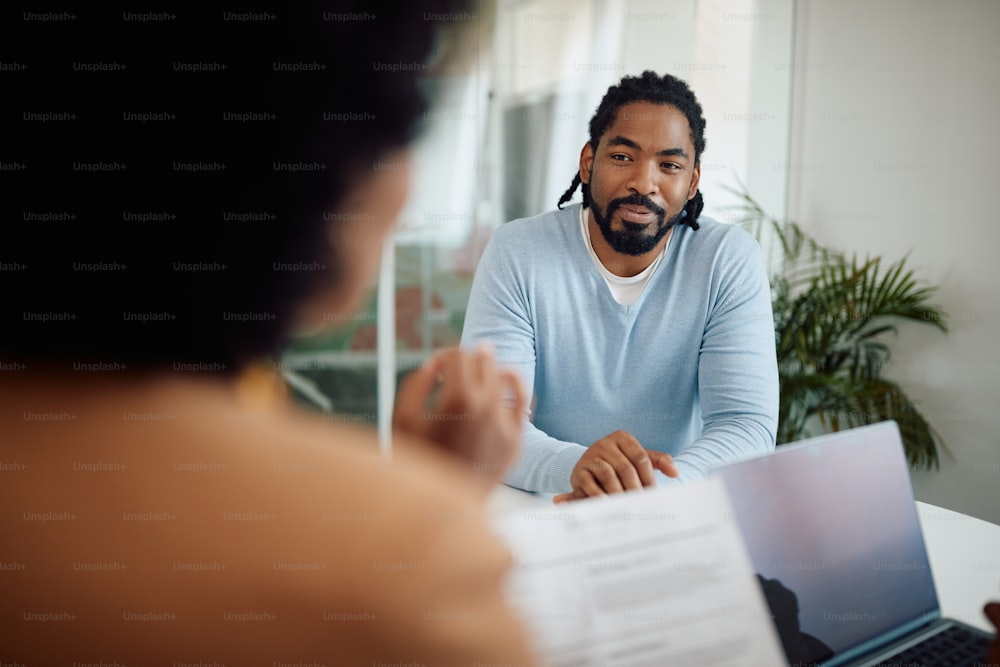 Smiling African American candidate having job interview in the office.