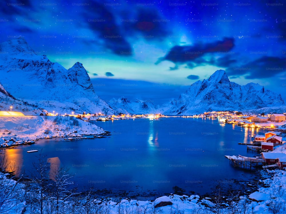 Reine village illuminated at night with Aurora Borealis. Lofoten islands, Norway