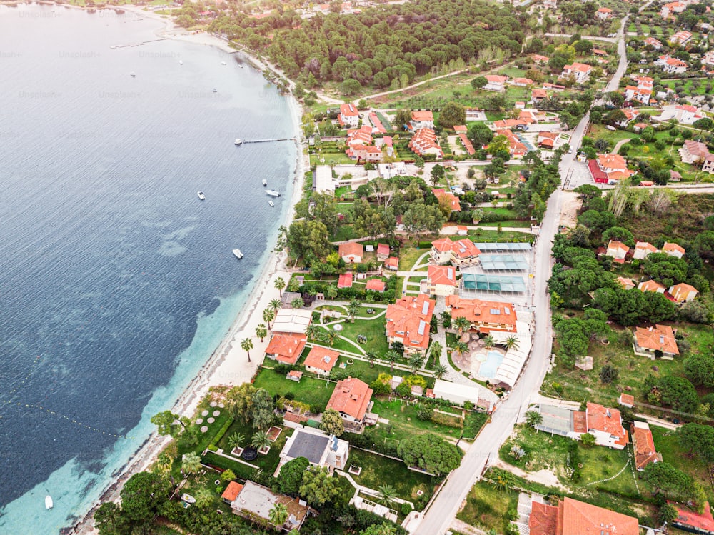 Aerial view of the idyllic seascape on the Sithonia peninsula in Halkidiki. High above the roofs of the resort Vourvourou village with villas and hotels.
