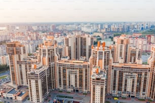 Huge residential area multi-storey high-rise buildings to the horizon, the evening sky aerial view