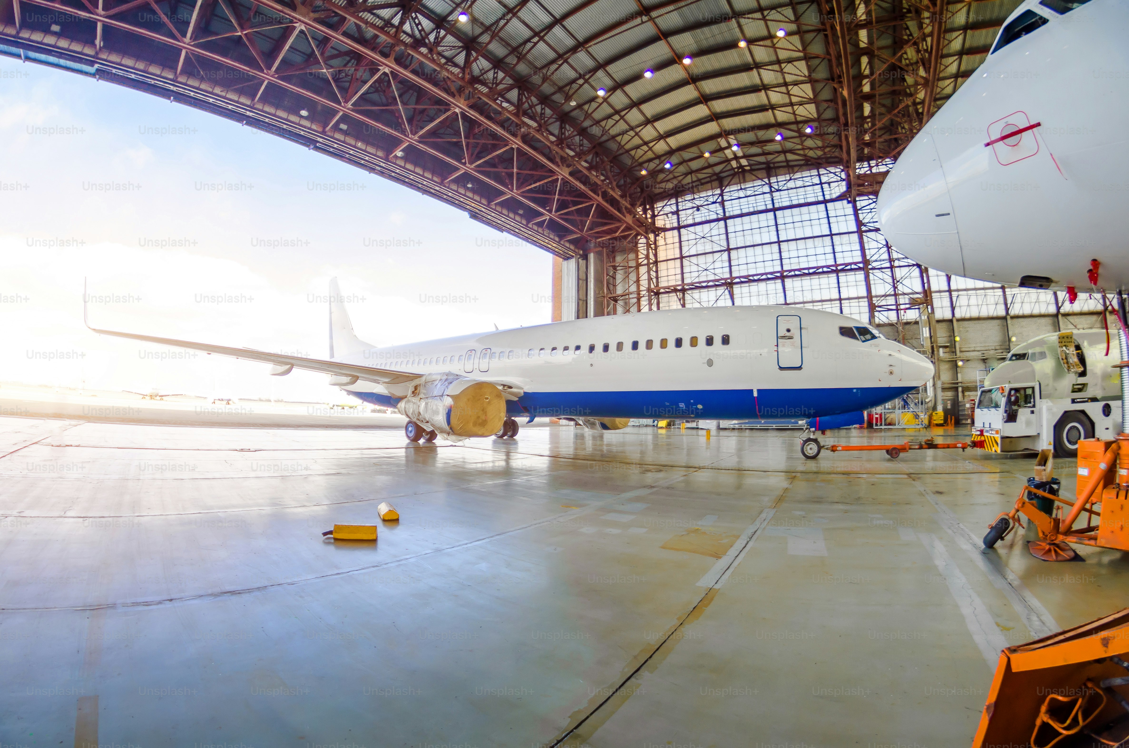 Roulage de l’avion hors du hangar par un tracteur, après réparation