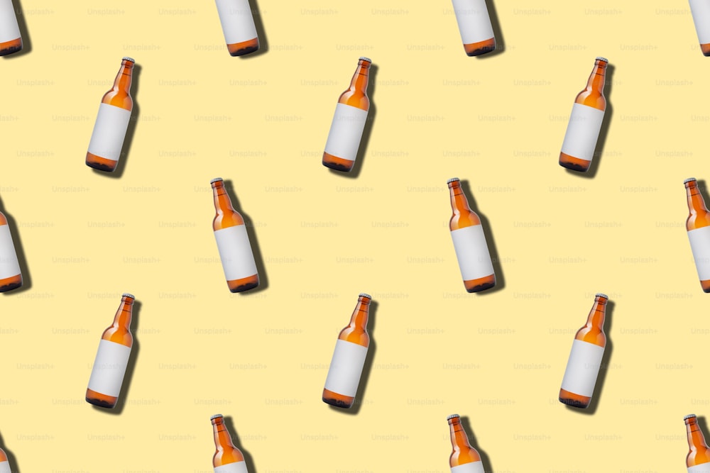 Seamless pattern with glass beer bottle on yellow background. Minimal style, flat lay