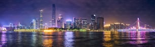 Guangzhou cityscape skyline over the Pearl River with Liede Bridge illuminated in the evening. Guangzhou, China