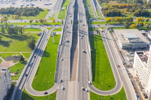 Aerial view of the intersections of the city highway. Vehicles driving on the roads