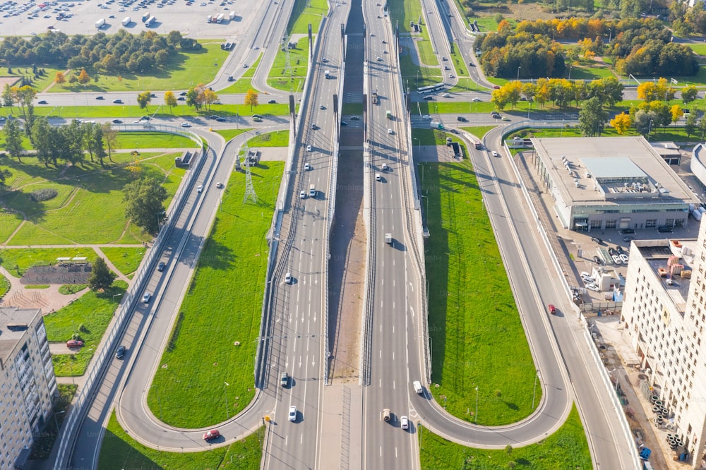 Aerial view of the intersections of the city highway. Vehicles driving on the roads