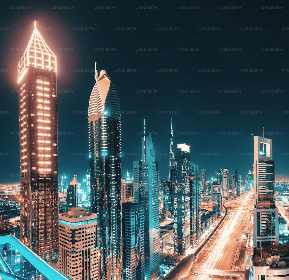 Night view of the spectacular landscape of Dubai with high-rises and skyscrapers at the Sheikh Zayed highway. Global travel destinations and real estate concept