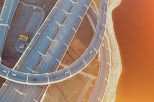 Aerial view highway loop over a road junction in the evening at sunset