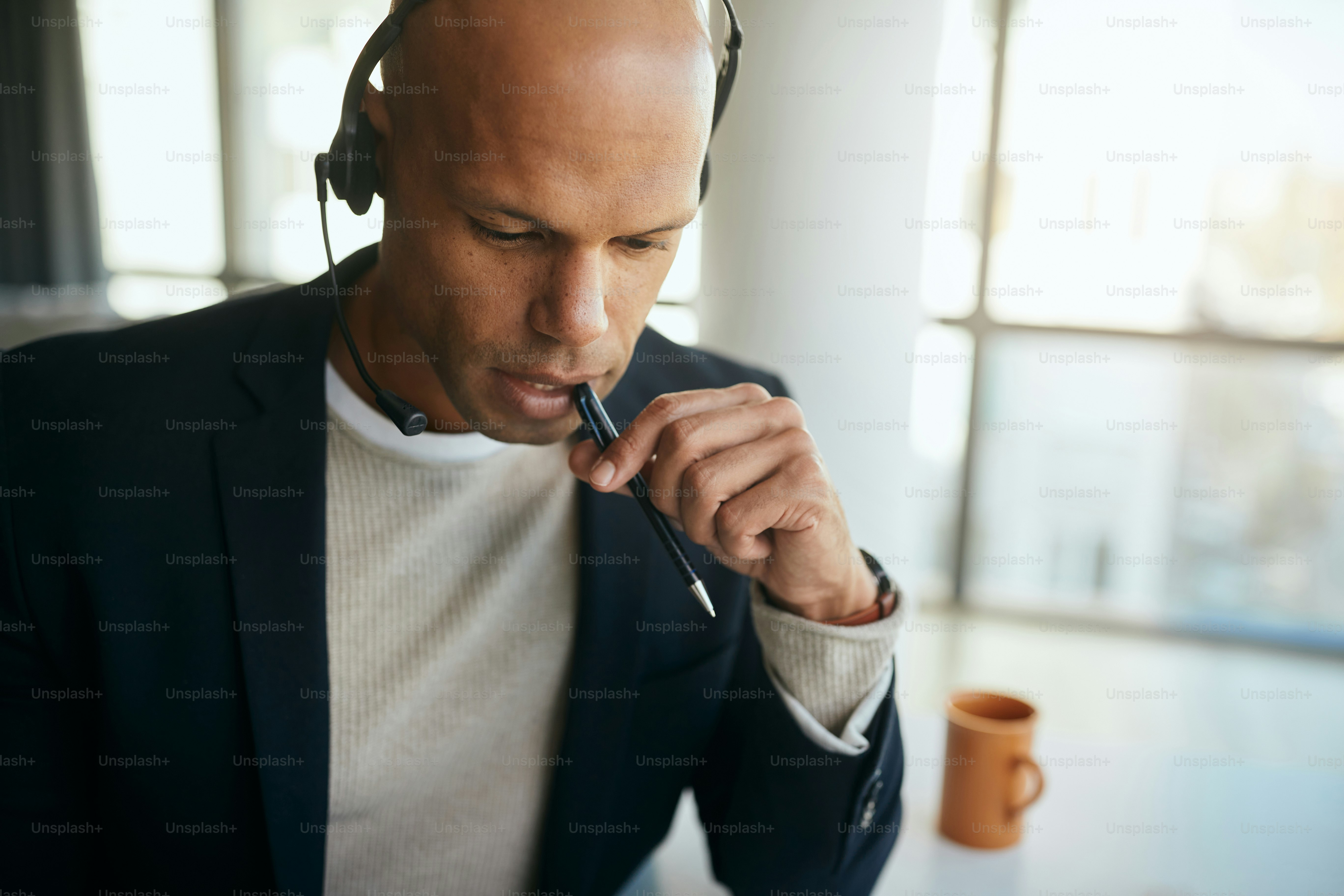 Pensive African American businessman thinking while working in the office.