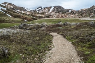 Beautiful Landmanalaugar gravel dust road way on highland of Iceland, Europe. Muddy tough terrain for extreme 4WD 4x4 vehicle. Landmanalaugar landscape is famous for nature trekking and hiking.