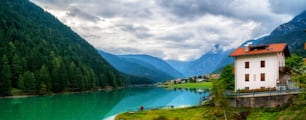 Beautiful mountain village landscape of Villapiccola and Lake Auronzo in Auronzo di Cadore, northern Italy. Nature and countryside panoramic landscape.