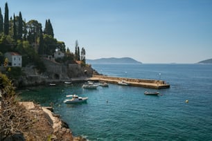 Adriatic coast with sunny harbor in Trsteno, Dalmatia, Croatia. Tourist attraction near Dubrovnik.