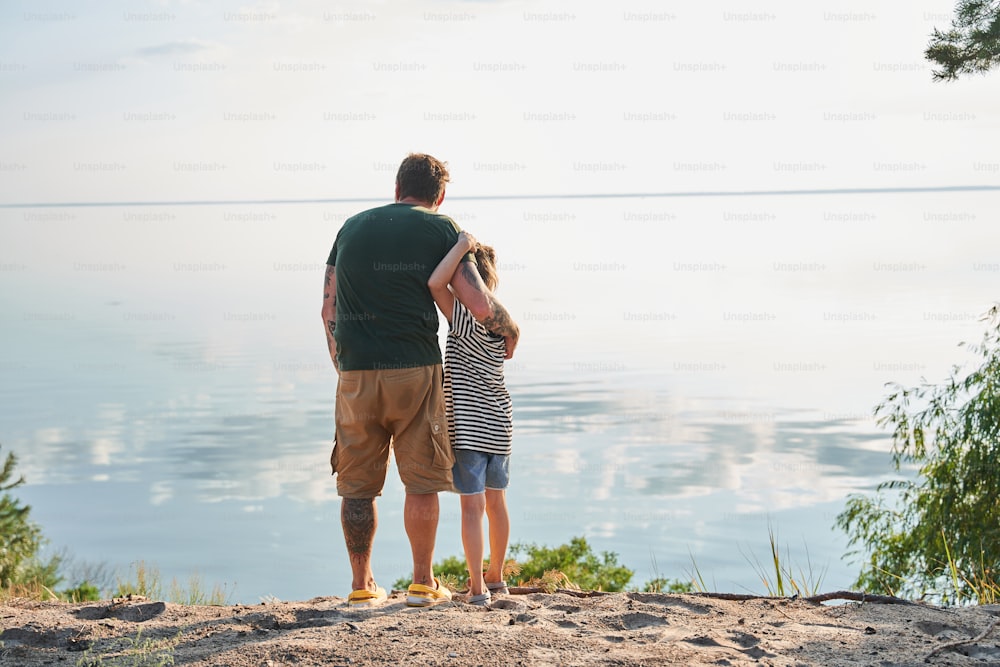 Father and daughter exploring new places together. Child girl and her daddy spending time together at the nature. Stock photo