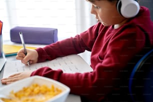 Close up side view of boy doing math homework