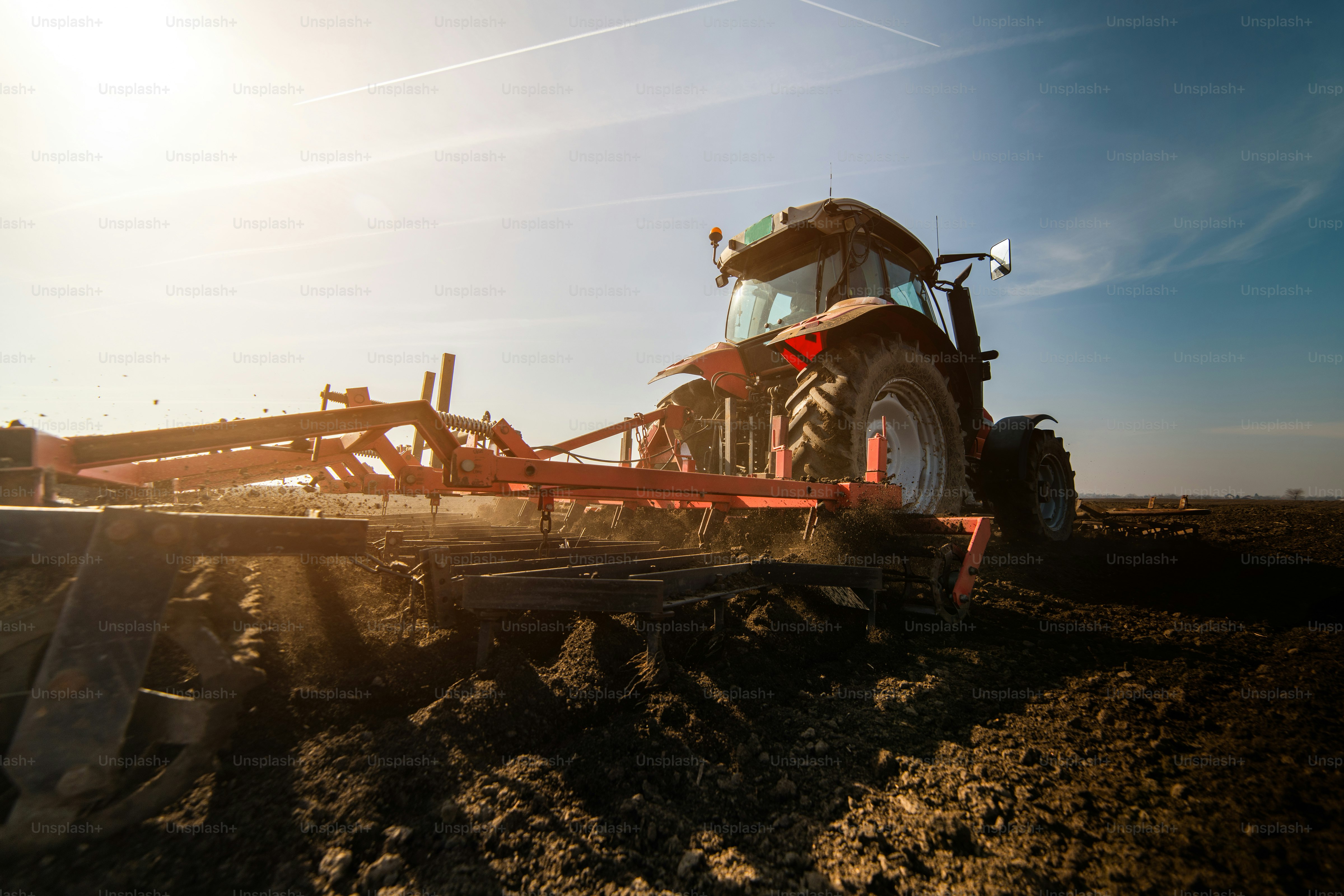 Tractors plowing stubble fields