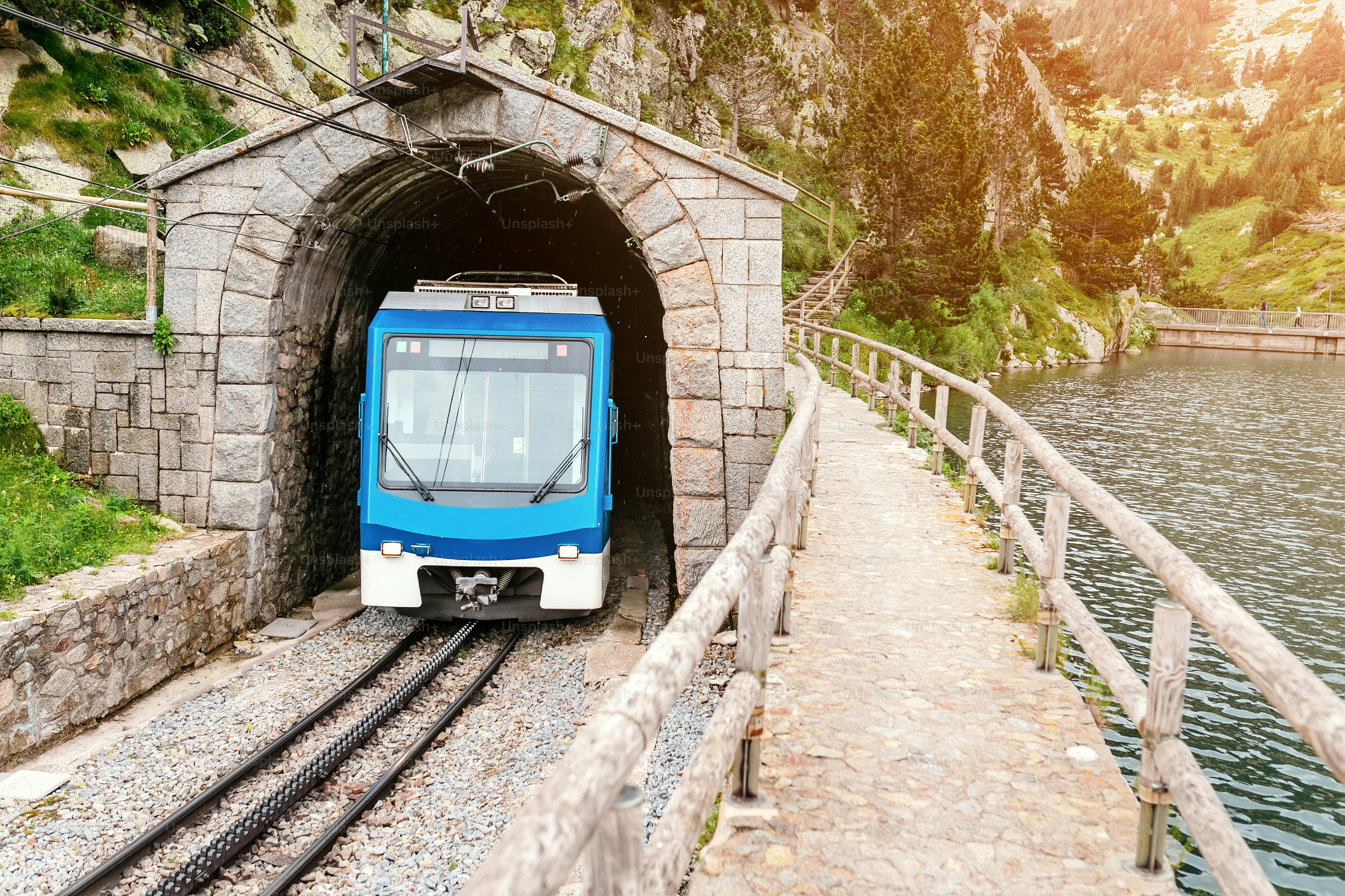 The train leaves the tunnel in the mountains