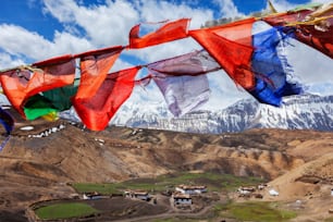 Buddhist prayer flags in sky over Comic Village. Comic Village, Spiti Valley, Himachal Pradesh, India