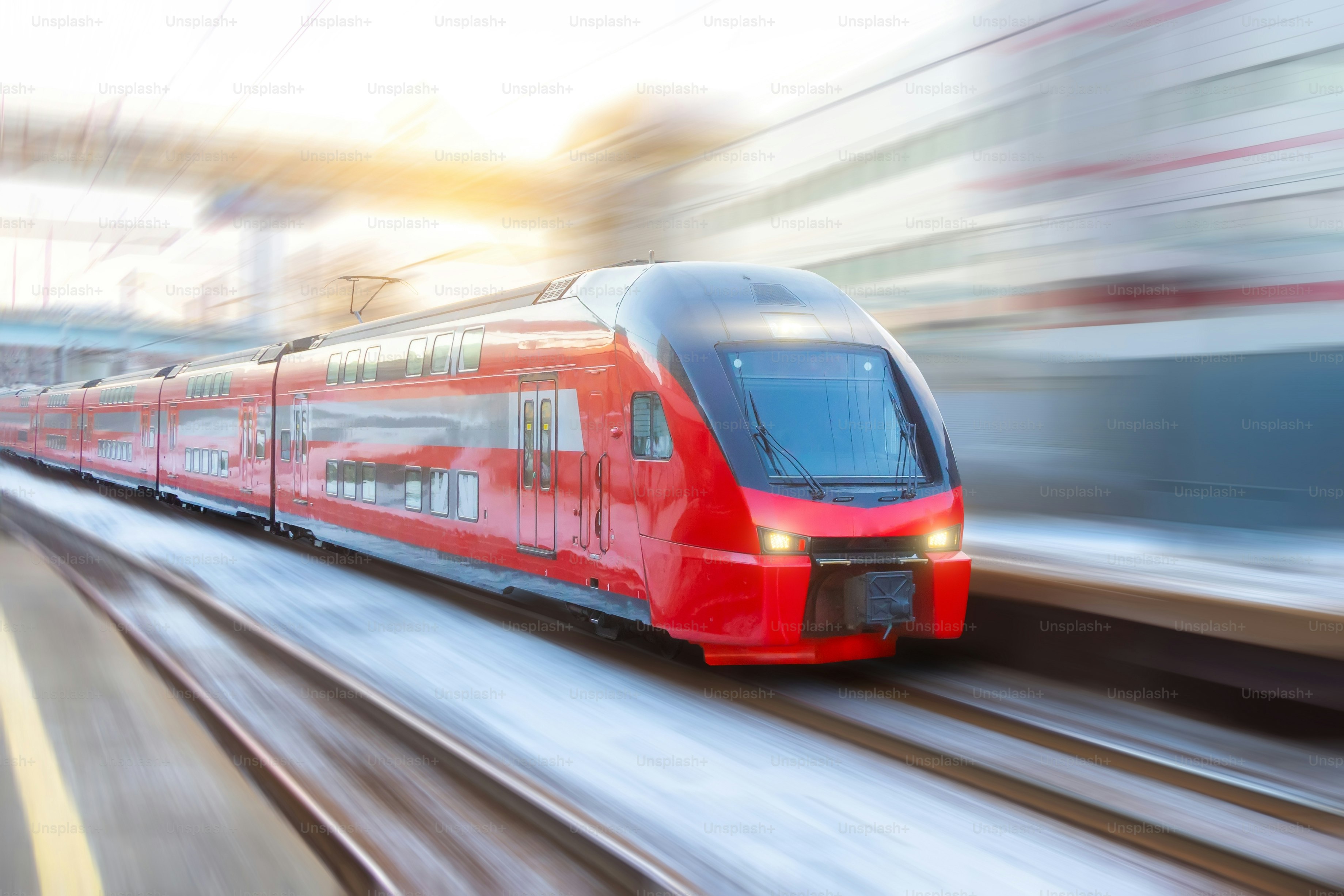 Speed double decker express train arrives at a station in the city